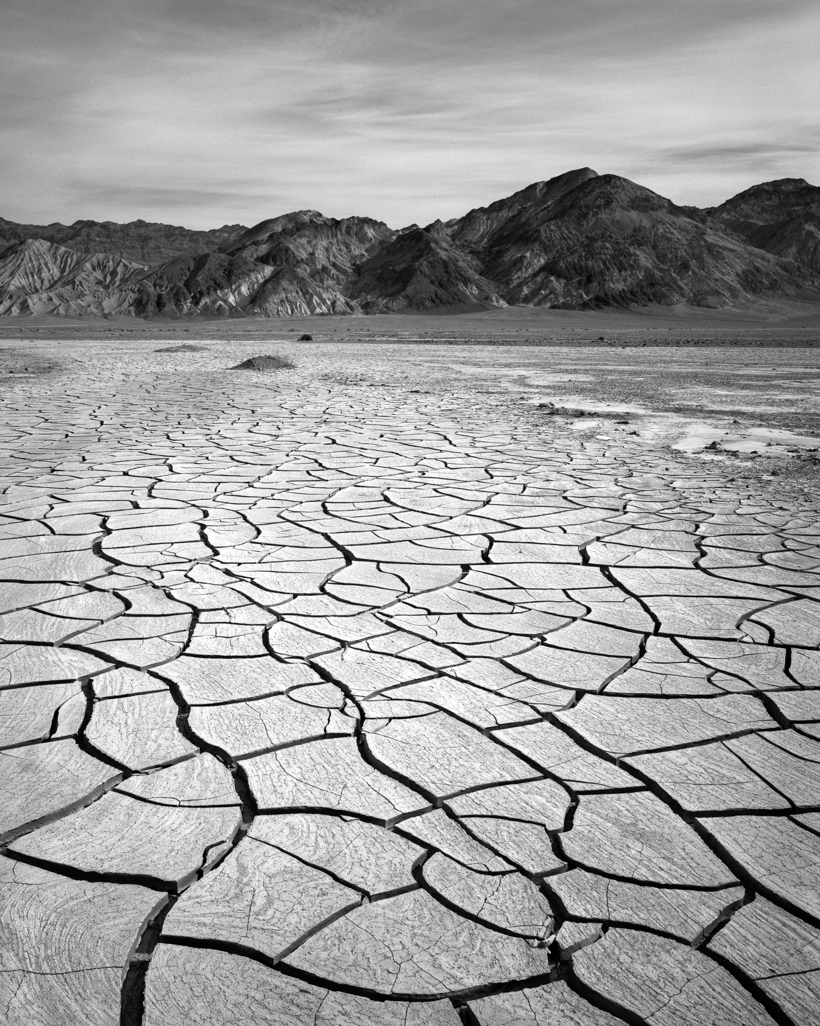 The cracked mud flats between Furnace Creek and the Black Mountains do something interesting in winter morning light, California. Photograph by Marty Quinn
